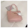 Détail d'un sac à épaule en cuir rose avec nœud mignon et pendentif étoile élégant - Avec Pendentif / Rose