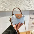 Denim dumpling crossbody bag for women, trendy French niche shoulder handbag with star studs. - Blue