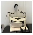 Minimalist casual white shoulder messenger bag with black zippers and stylish commuter design. - White