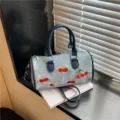 Chic denim Boston bag featuring charming cherry embroidery and stylish top handles. - With Pendant / Blue