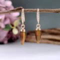 Primo piano dettaglio di orecchini vintage in pietra naturale con gancio in zirconio. - Topazio