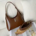 Stylish brown leather shoulder bag for women, elegant hobo design with metal lock and pouch. - Coffee