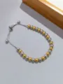 Bracciale scorrevole con perline bicolore in acciaio inossidabile, dettaglio gioiello in metallo. - Bicolore Oro e Argento