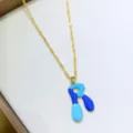 Squisita collana con lettere smaltate e vivaci toni blu con catena dorata lucida. - Lettera R