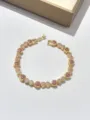 Elegante bracciale tennis dorato con zirconi a cuore rosa e bianchi scintillanti. - Cuore Rosso Rosa
