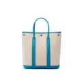 Vertical canvas tote bag with blue leather trim, stylish shoulder handbag for daily use. - Frida Blue