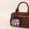 Brown PU leather handbag detail view featuring a cute cartoon character horse charm accessory. - BHT67 Heart Horse