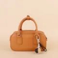 Brown leather handbag detail featuring stylish braided ball pendant and metal hardware. - SJQ21 Gray - Gold Buckle / Gray