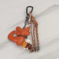 Close-up detail of the luxury style leather animal keychain charm with colorful braided ropes. - Bag Charm 17