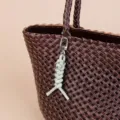 Leather woven bag charm keychain with metal clasp for stylish everyday use and decoration. - Light Green