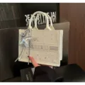 White canvas tote bag featuring starry pattern, horizontal band and cute star charm detail. - With Charm / White