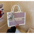 Close-up of stylish contrast dot tote handbag with silver star pendant for women style. - With Charm / Purple