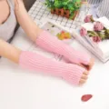 Pink knitted arm warmers, fingerless sleeves for sun protection and stylish daily wear. - One Size / Pink