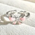 Close-up of a sweet pink enamel bow open ring with sparkling cubic zirconia, delicate design. - Pink Enamel Bow Knot (JZ1507A) / Silver