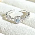 Detailed close-up of a sweet open silver ring featuring a sparkling light blue center stone. - Light Blue Round Zirconia (JZ2015A) / Silver