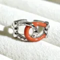 Close-up of a sweet style silver-plated enamel open ring with coral red detail, chic accessory. - Adjustable Open / Red Coral Interlocking Buckle Style (JZ2229A) / Silver