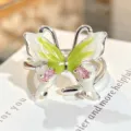 Close-up detail of the green enamel butterfly ring featuring pink zircon stones and shiny finish. - Adjustable Open / Gradient Enamel Butterfly Style (JZ1613A)