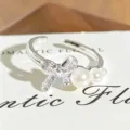 Adjustable silver ring featuring a sparkling rhinestone bow and elegant pearl embellishments for women. - Gradient Pearl Bowknot Style (JZ0544A) / Adjustable Open