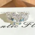 Close-up detail of silver open ring with sparkly cubic zirconia and light blue enamel bow. - Blue Enamel Bowknot Style (JZ1406A) / Adjustable Open