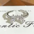 Detailed close-up view of a sparkling zircon and pearl bow open ring with exquisite design. - Pearl Micro-Inlaid Bowknot Style (JZ4548A) / Adjustable Open