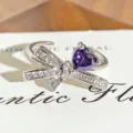 Close-up detail of silver bow open ring featuring sparkling white zircons and purple heart stone. - Purple Heart Bowknot Style (JZ4975A) / Adjustable Open