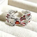 Silver tone gothic bone shape open ring with red enamel and central crystal stone detail. - Red Gem Intertwined Style (JZ0654A)