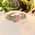Detailed close-up of a stunning heart-shaped pink zircon open ring with delicate side crystals. - Adjustable Open / Pink Diamond Dense Pave Style (JZ2986B)