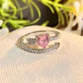 Detailed close-up of a pink heart zircon arrow open ring, sparkling cubic zirconia pavé. - Adjustable Open / Pink Diamond Cupid Arrow Style (JZ3937)