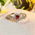Close-up detail of the sparkling heart-shaped red gemstone ring with crystal rhinestones. - Adjustable Open / Red Diamond Luxury Micro Pave (JZ3945)
