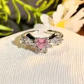 Detailed close-up of pink heart zircon open ring with sparkling cubic zirconia crystals. - Adjustable Open / Pink Diamond Bow Wing Style (JZ4046A)