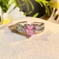 Close-up of exquisite pink heart zircon open ring with sparkling paved split band details. - Adjustable Open / Pink Diamond Double Cross Over (JZ5653)