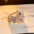 Silver open ring featuring purple and clear zirconia stones in delicate floral cluster designs. - Double Flower Inlaid Style (JZ0965A) / Adjustable Open