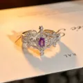 Exquisite detailed close-up of a hollow floral open ring featuring a sparkling purple oval zircon. - Vintage Hollow Flower Style (JZ4787A) / Adjustable Open