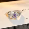 Close-up detail of a delicate floral open ring featuring a sparkling purple cubic zirconia. - Purple Oval Leaf Style (JZ5469) / Adjustable Open