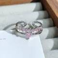 Close-up detail of the delicate double-band pink zircon heart ring, sparkling and chic. - Heart Round Pink Zirconia Style (JZ3995A) / Silver