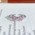 Close-up detail of the sparkling pink heart bow ring, silver metal band, elegant shine. - Double Heart Bowknot Style (JZ1208A)
