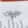 Detailed close-up of a silver open ring featuring a pink zircon bow design and sparkling stones. - Sweet Bowknot Style (JZ4366)