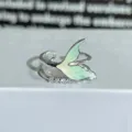 Close-up detail view of silver open ring featuring green enamel tail and sparkling zirconia stones. - Adjustable Open / Green Enamel Fishtail Zirconia Style (JZ3067A)