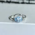 Detailed close-up of a silver adjustable ring featuring a cute glittery blue headphone character. - Adjustable Open / Light Blue Cartoon Headphones Style (JZ4625A)