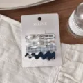 Close-up of blue plaid hair clips set, featuring pearl and metal details on card. - Cross Silver Wave Double Bead Clip