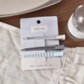 Detailed view of blue checkered and solid hair clips set on white display card. - Blue Stripe Flat Duckbill Clip