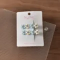 Detailed shot of cute blue and white floral hair clips with rhinestones on card display. - Sparkle 4 Small Flowers / 2 Pieces/Pack / Blue Series