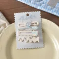 Detalle del conjunto de pinzas para el cabello lindas con diseños de cuadros y flores. - Juego de 4 / 7# Lazo con Cuenta Azul en Forma de 8