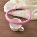 Close-up of the pink striped headband detail, showing soft fabric texture, narrow edge and handmade label. - Rose Pink