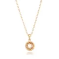 Close-up detail of the gold-tone chain necklace featuring a sparkling faceted champagne zircon pendant. - Gold November