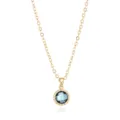 Detailed view of a gold-plated necklace featuring a blue faceted gemstone pendant and fine chain. - Gold December