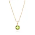 Close-up detail of the gold-plated green gemstone pendant necklace with fine chain. - Gold August