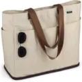 Große beigefarbene Segeltuch-Tragetasche mit braunen Trägern für Reisen und den Alltag. - Beige