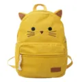 Cute yellow corduroy cat backpack detail, showing embroidered face and cat ears. - Yellow