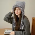 Detailed view of the cute cat ear knitted winter warm braided plush earflap hat in gray. - Gray